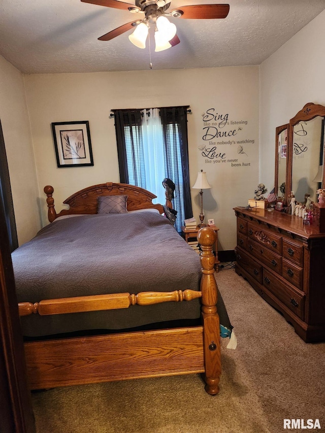 carpeted bedroom featuring ceiling fan and a textured ceiling