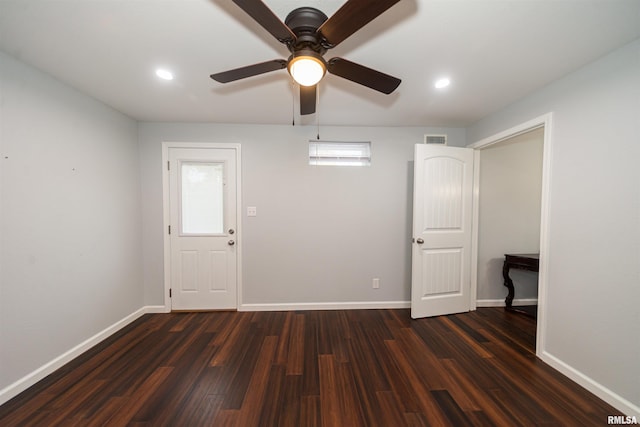 interior space with ceiling fan and dark hardwood / wood-style floors