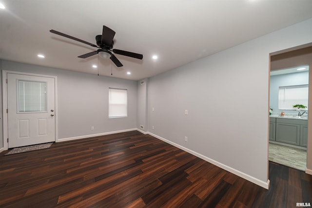 spare room featuring ceiling fan and dark hardwood / wood-style floors