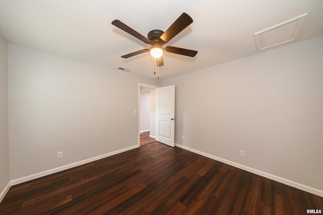 empty room with ceiling fan and dark hardwood / wood-style flooring