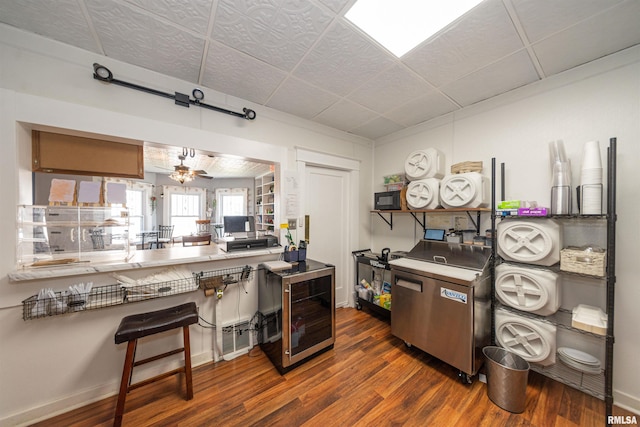 kitchen featuring ceiling fan and dark hardwood / wood-style floors