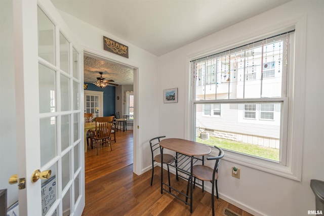 dining room featuring ceiling fan, dark hardwood / wood-style flooring, and french doors