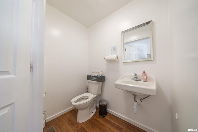 bathroom featuring hardwood / wood-style floors and toilet