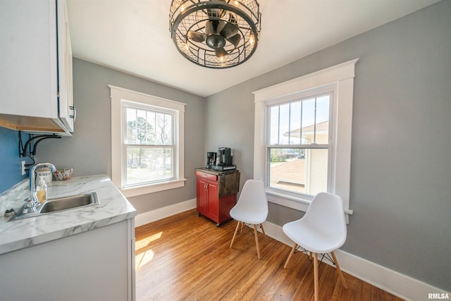 office area with sink and light hardwood / wood-style flooring