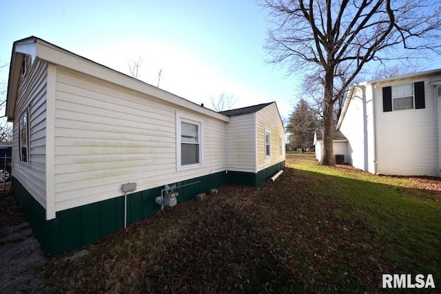 view of property exterior with a yard