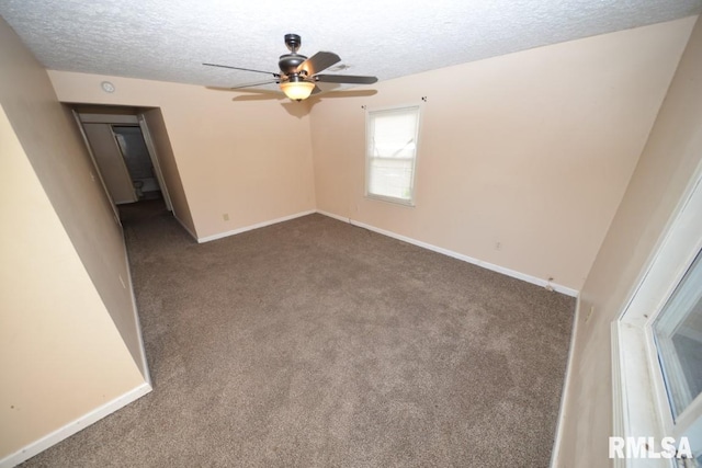 empty room with a textured ceiling, ceiling fan, and carpet