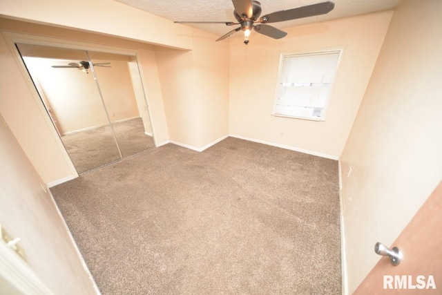 empty room featuring a textured ceiling, ceiling fan, and carpet floors