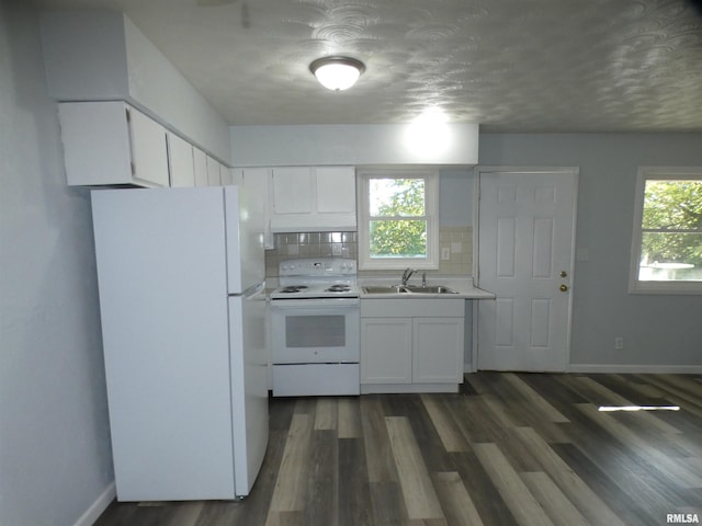 kitchen with white cabinetry, sink, plenty of natural light, and white appliances