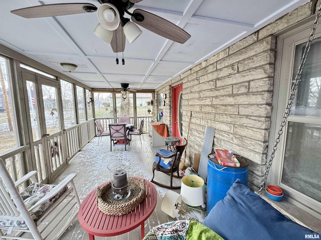 sunroom / solarium with ceiling fan and coffered ceiling