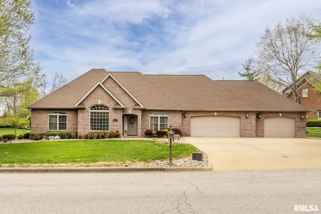 view of front facade featuring concrete driveway, a front yard, brick siding, a garage, and a shingled roof