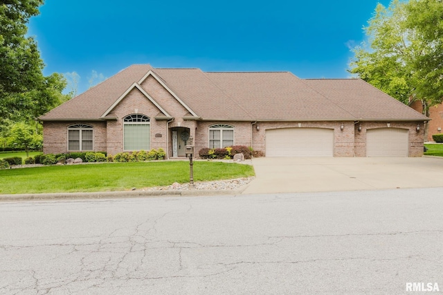 2730 Kokopelli Dr, Marion, IL 62959 - view of front facade featuring concrete driveway, brick siding, an attached garage, a front lawn, and roof with shingles
