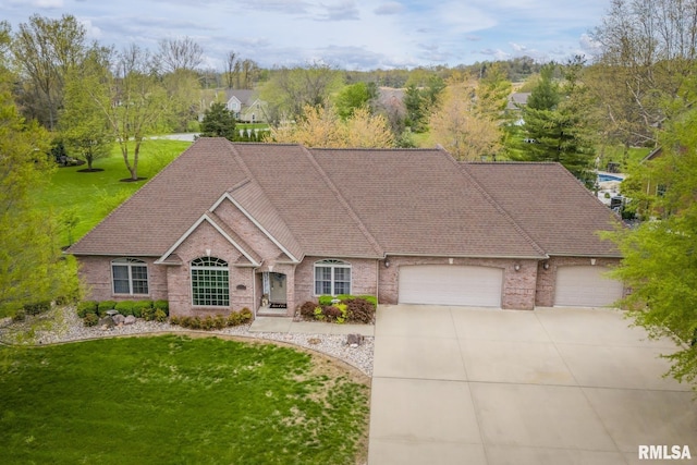single story home with an attached garage, driveway, a front yard, and brick siding