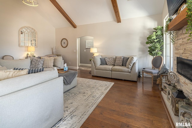 living room with a fireplace, dark wood-style floors, beam ceiling, high vaulted ceiling, and arched walkways