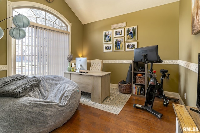 office space with baseboards, wood finished floors, and vaulted ceiling