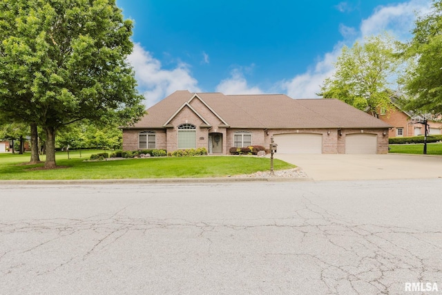 2730 Kokopelli Dr, Marion, IL 62959 - view of front facade featuring driveway, a garage, a front lawn, and brick siding