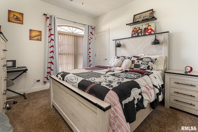 bedroom with dark colored carpet