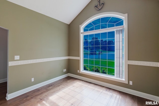 2730 Kokopelli Dr, Marion, IL 62959 - empty room featuring wood finished floors, vaulted ceiling, and baseboards
