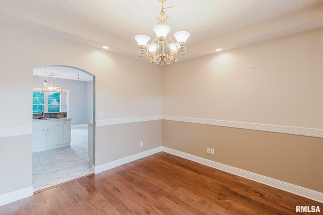 2730 Kokopelli Dr, Marion, IL 62959 - empty room with a chandelier, a sink, recessed lighting, wood finished floors, and arched walkways