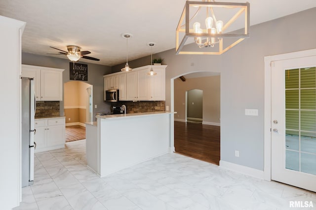 2730 Kokopelli Dr, Marion, IL 62959 - kitchen with stainless steel appliances, arched walkways, ceiling fan, light marble finish floors, and decorative backsplash