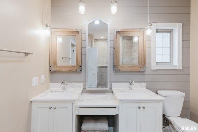 2730 Kokopelli Dr, Marion, IL 62959 - bathroom with double vanity, toilet, and wooden walls
