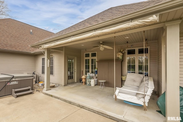 view of patio featuring ceiling fan and a hot tub