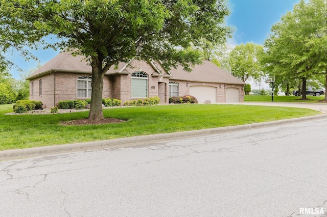 2730 Kokopelli Dr, Marion, IL 62959 - view of front of home featuring a garage, driveway, a front lawn, and brick siding