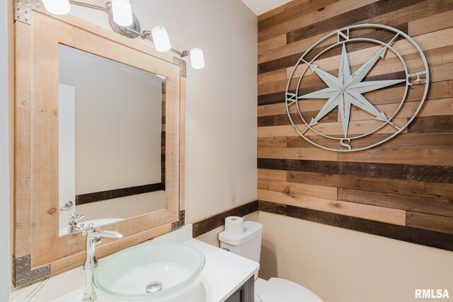 2730 Kokopelli Dr, Marion, IL 62959 - half bathroom featuring wood walls, vanity, and toilet