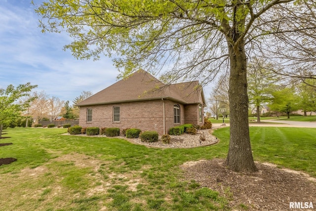 view of home's exterior featuring a yard and brick siding