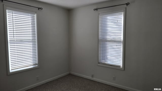 empty room with dark colored carpet