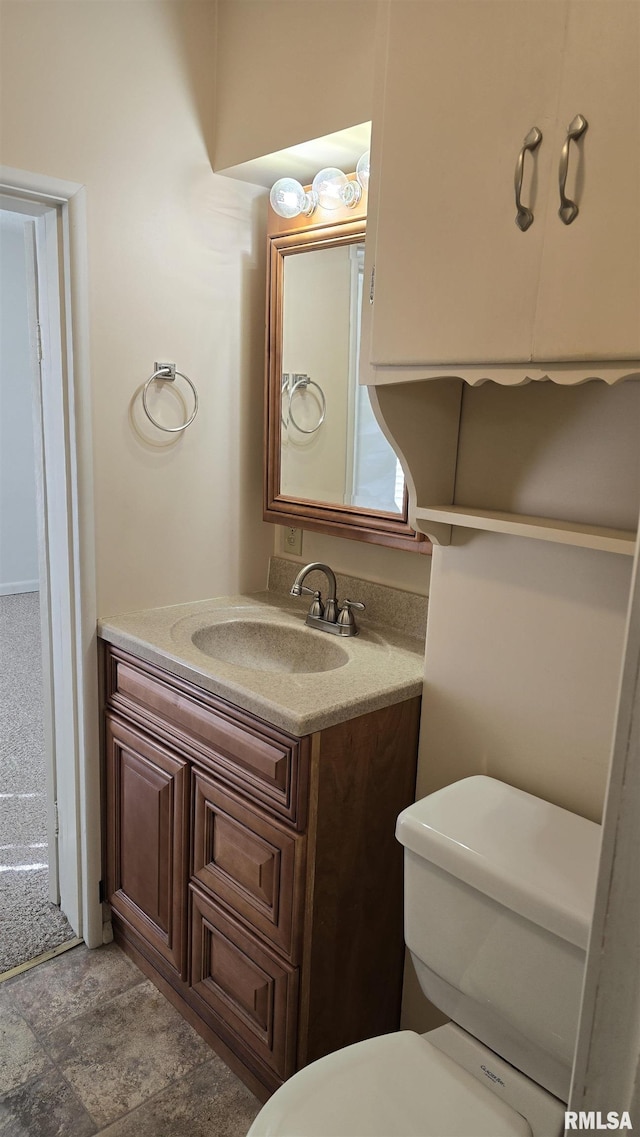 bathroom featuring toilet and vanity