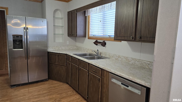 kitchen with light hardwood / wood-style floors, sink, appliances with stainless steel finishes, built in shelves, and dark brown cabinets