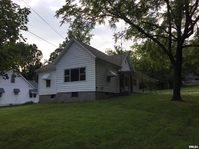 view of side of home featuring a yard