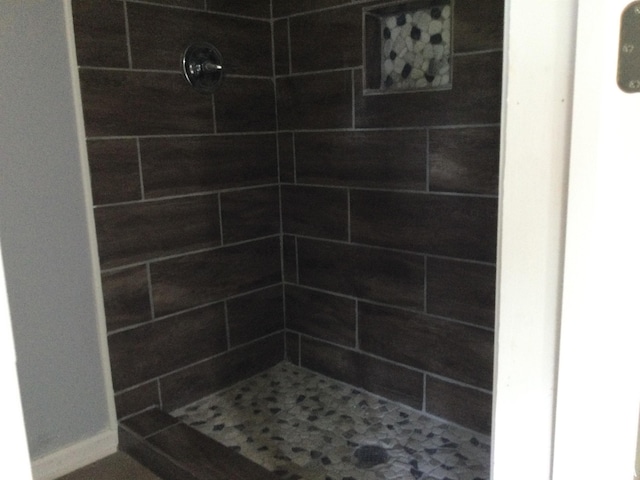 bathroom with tiled shower