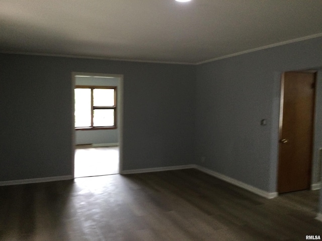 empty room featuring crown molding and dark hardwood / wood-style floors