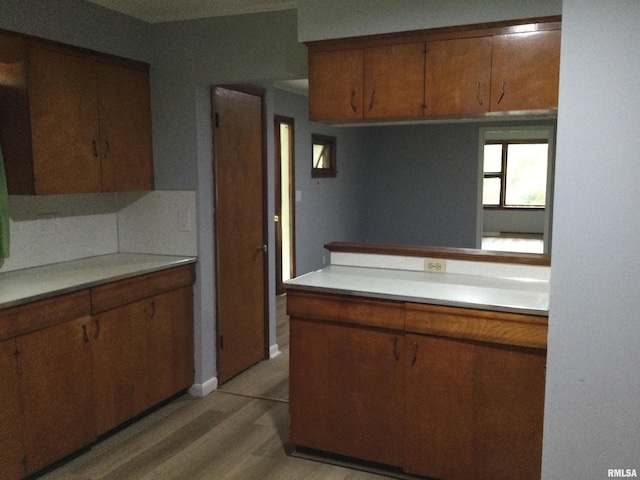 kitchen featuring light hardwood / wood-style floors and decorative backsplash