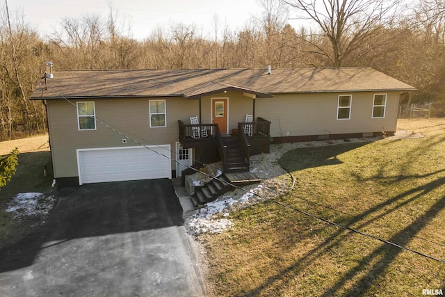 ranch-style home with a garage and a front lawn