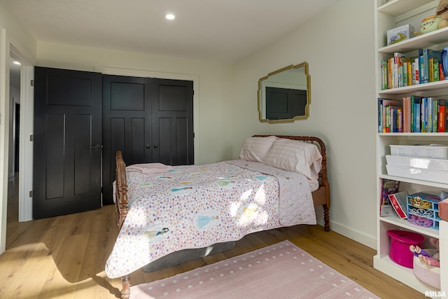 bedroom featuring light hardwood / wood-style floors and a closet