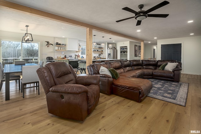 living room featuring light hardwood / wood-style flooring and beamed ceiling