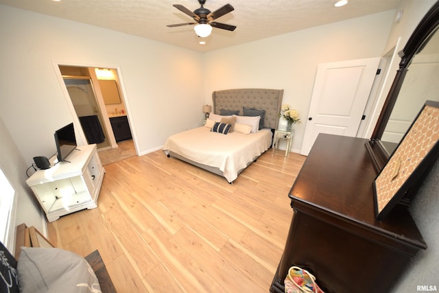 bedroom with ceiling fan, a closet, light hardwood / wood-style flooring, and ensuite bath