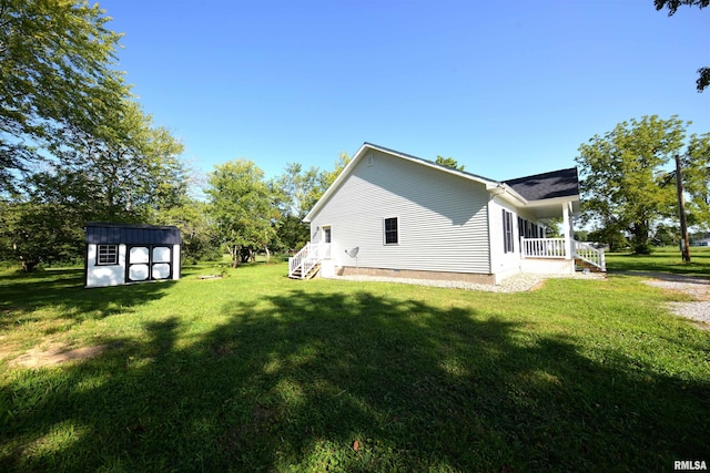 view of side of property with a yard and a shed