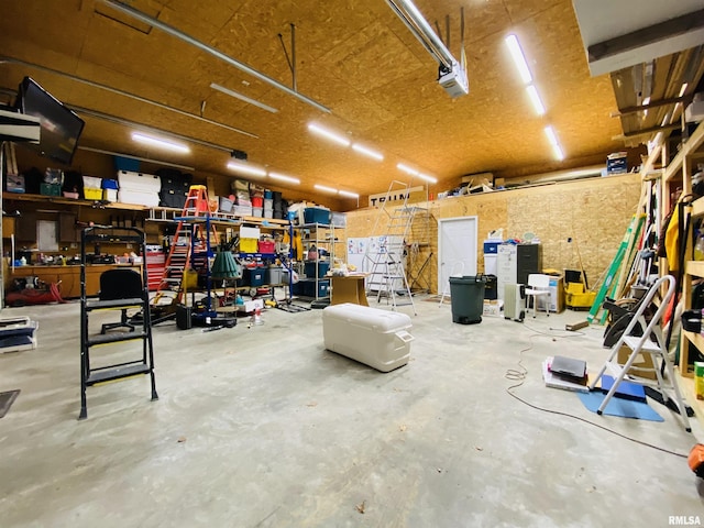 garage with a garage door opener and a workshop area