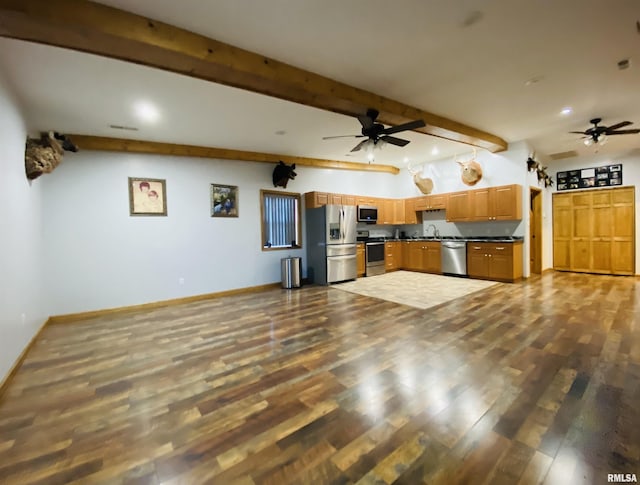 kitchen with sink, stainless steel appliances, beam ceiling, and dark hardwood / wood-style flooring