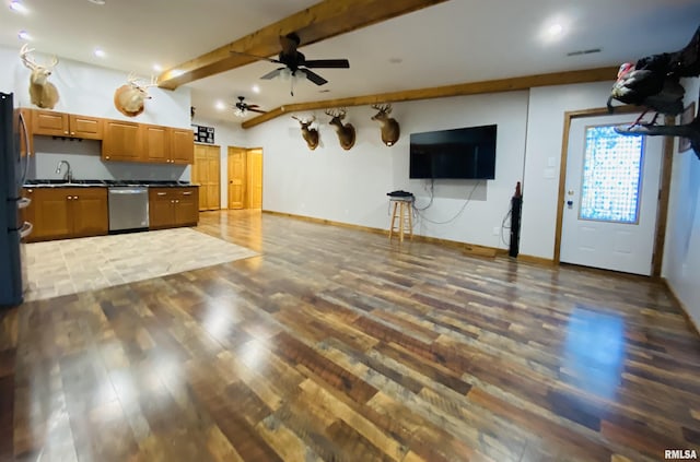 kitchen featuring appliances with stainless steel finishes, dark wood-type flooring, beamed ceiling, sink, and ceiling fan