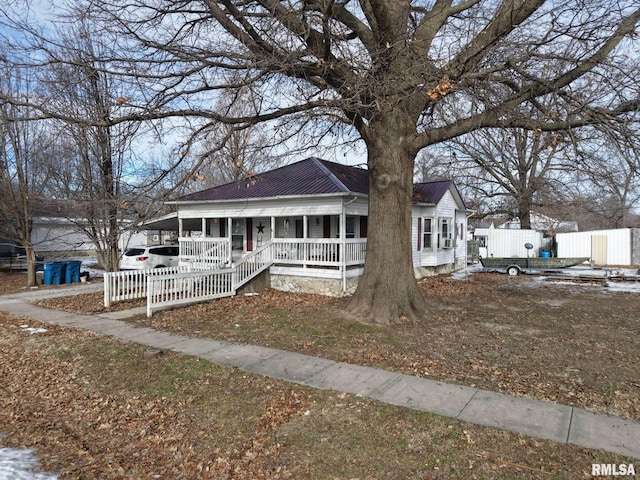 view of front of property featuring a porch and a carport