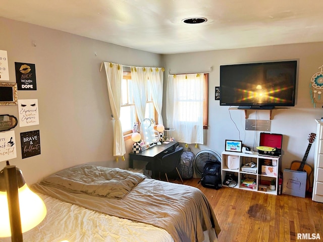 bedroom with hardwood / wood-style flooring