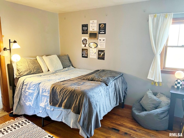 bedroom with dark wood-type flooring