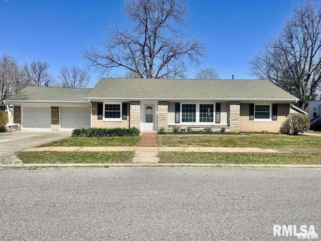 ranch-style home with a garage and a front lawn