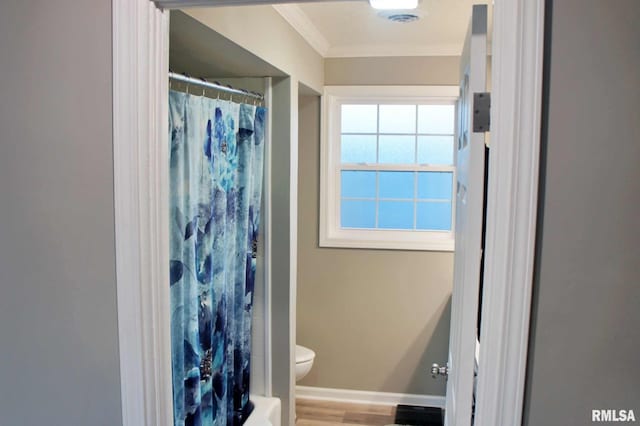 bathroom with crown molding, wood-type flooring, toilet, and walk in shower