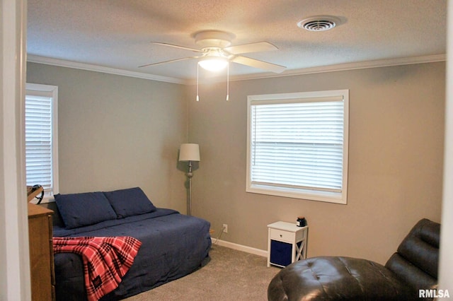 bedroom with crown molding, carpet floors, a textured ceiling, and ceiling fan