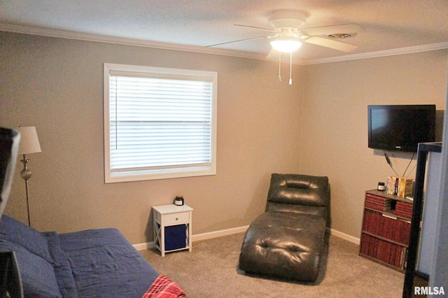 sitting room featuring carpet floors, crown molding, and ceiling fan